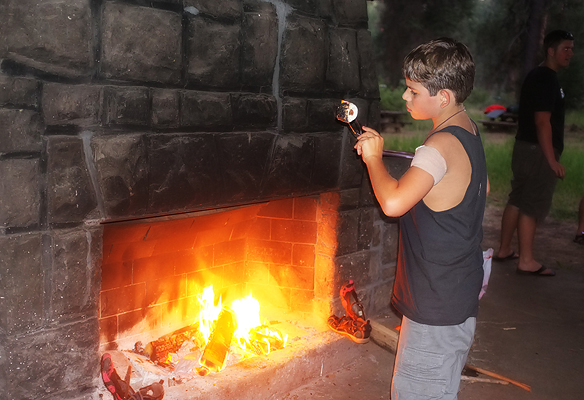 Roasting the perfect marshmallows stuffed with Rolos.