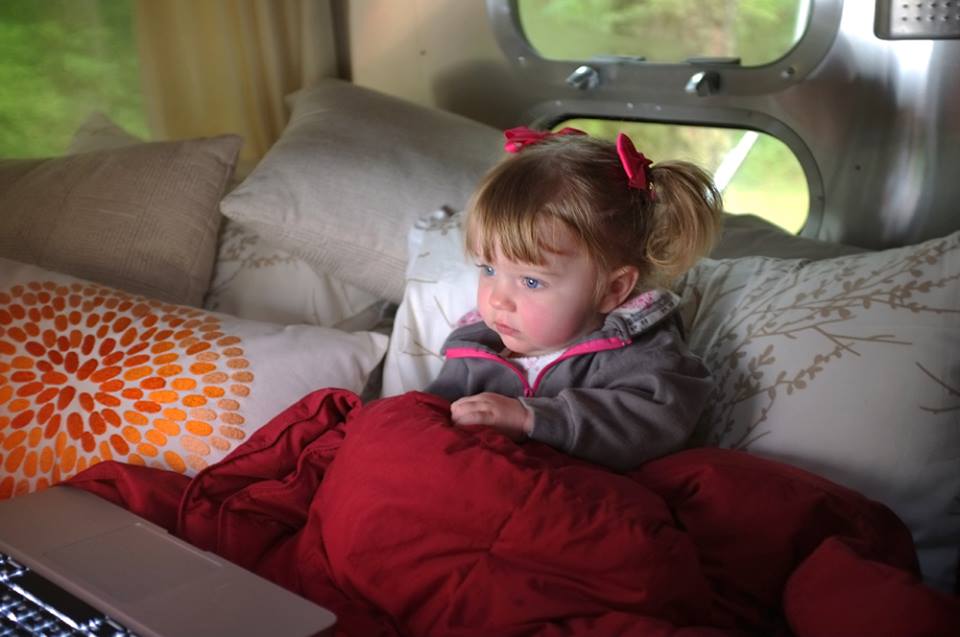Cuddled under a blanket waiting for the rain to pass.